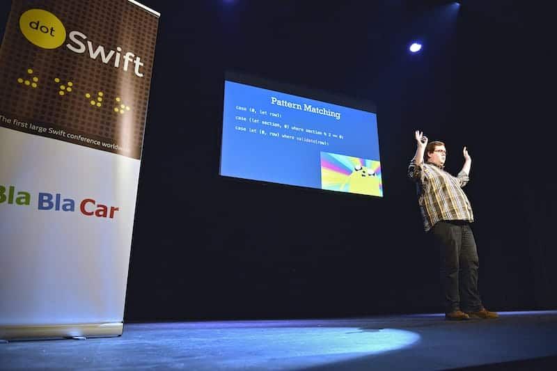 Photo of me presenting at a conference about Swift.