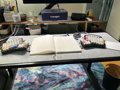 Photo of my ErgoDox on my desk with a notepad in the middle